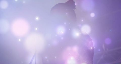 Energetic Male Vocalist Illuminated on Hazy Concert Stage