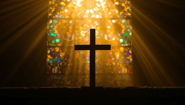 Sunlit cross silhouette with stained glass rays and dust particles on altar rail