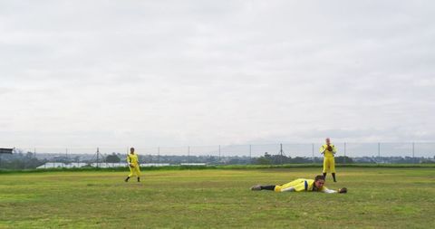 Female Athlete Securing Catch in Vibrant Yellow Sports Uniform
