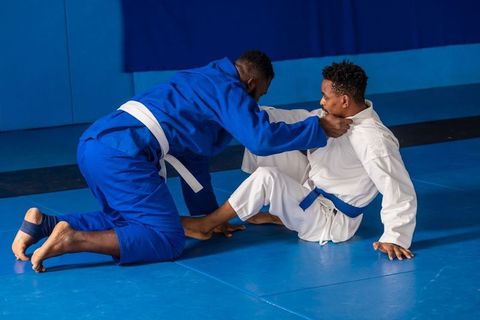 Martial Arts Training Spar Match Between Partners Wearing Gis