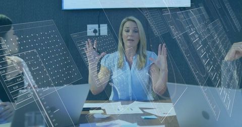 Businesswoman leading meeting with digital chart overlays