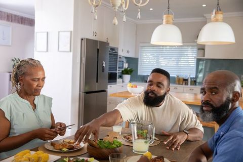 Family Enjoying Meal Together in Modern Kitchen Setting