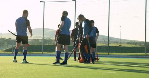 Field Hockey Team Strategizing on Turf