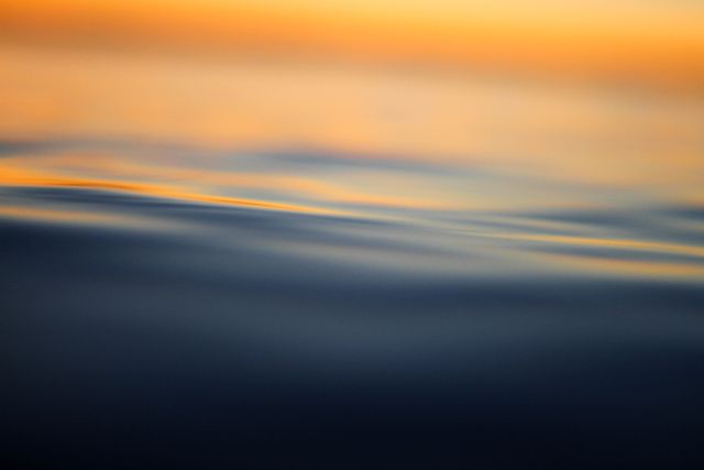 Gentle Waves and Evening Sun Glow on Water Surface - Download Free Stock Photos Pikwizard.com
