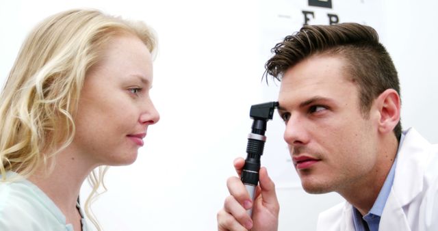 Optometrist Examining Patient's Eyes with an Ophthalmoscope - Download Free Stock Images Pikwizard.com