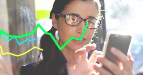 Female professional tapping smartphone with bright financial charts overlay in urban sunlight