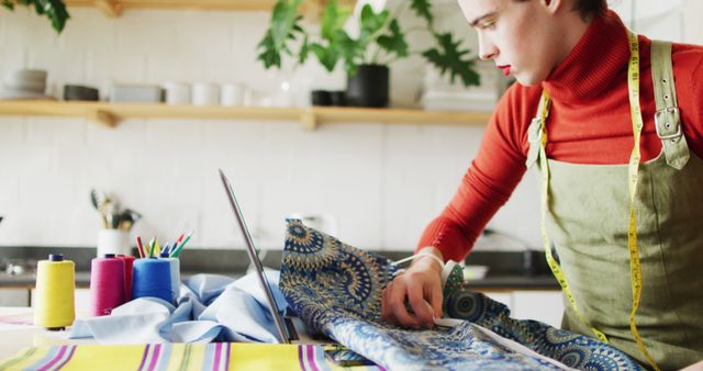 Caucasian non-binary transgender woman working at home, sewing - Download Free Stock Photos Pikwizard.com