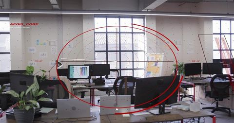 Loft Office Workstations Displaying Monitors and Laptops with Red UI Overlay