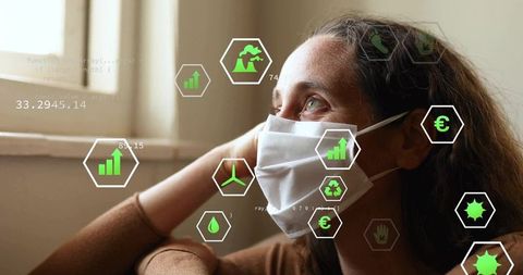 Woman in mask reflecting by window with digital eco icons