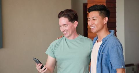 Happy Diverse Couple Video Chatting At Home, Sharing Joyful Moments