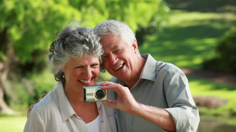Happy Senior Couple Taking Selfie in Serene Countryside