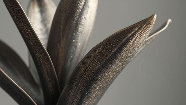 Gleaming bronze leaf sculpture detail with hammered texture and metallic patina