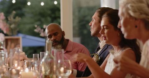 Wedding Guests Smiling and Socializing at Festive Dinner