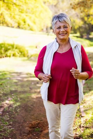 Senior Woman Walking in Park Enjoying Active Lifestyle