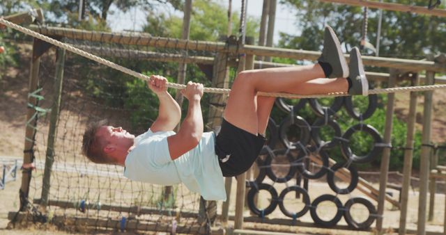 Man climbing rope obstacle at outdoor adventure park - Download Free Stock Images Pikwizard.com