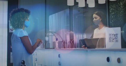 Masked receptionist accommodating visitor with safe practices