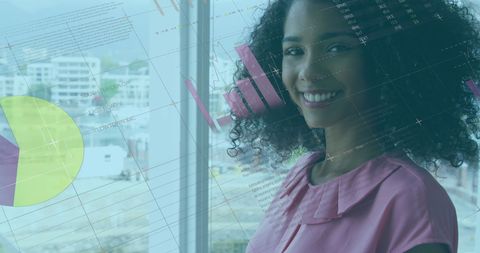 Smiling african american businesswoman with financial data projection