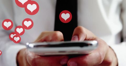 Man engaging on smartphone with heart icons overlay