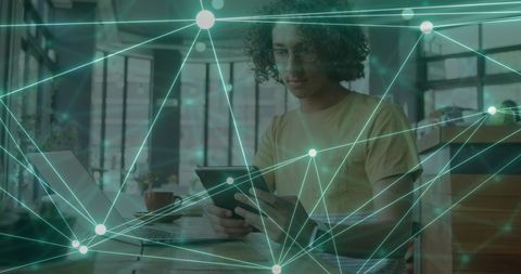 Man engaging with digital network interface using tablet