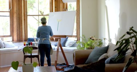 Senior Woman Enjoying Painting in Sunlit Room at Home - Download Free Stock Images Pikwizard.com