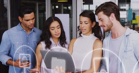 Diverse Business Team Analyzing Data with Technology Icons