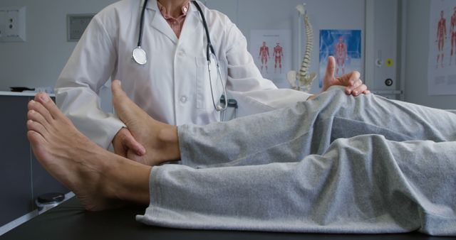 Caucasian female physiotherapist treating knee of patient in therapy room. Physiotherapy, treatment, rehabilitation, medical services, healthcare and hospital.