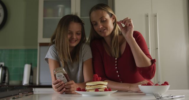 Mother and Daughter Enjoying Making Pancakes Together in Kitchen - Download Free Stock Images Pikwizard.com