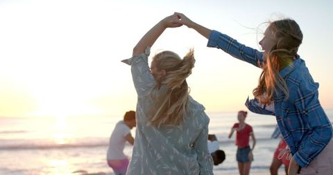 Joyful Sunset Dance by the Beach with Friends - Download Free Stock Images Pikwizard.com