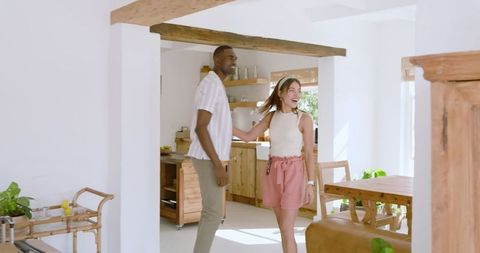 Diverse Couple Enjoying Rustic Kitchen Interior Together