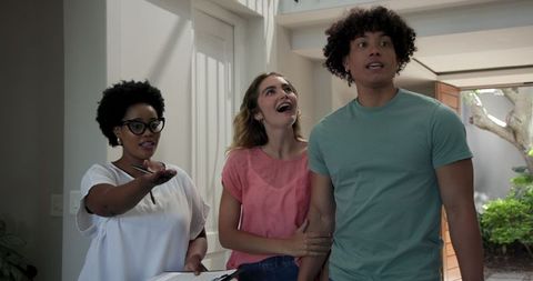 Welcoming Couple with Real Estate Agent in Bright Modern Home