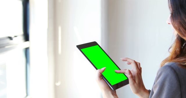 Person Using Tablet with Green Screen near Window - Download Free Stock Images Pikwizard.com