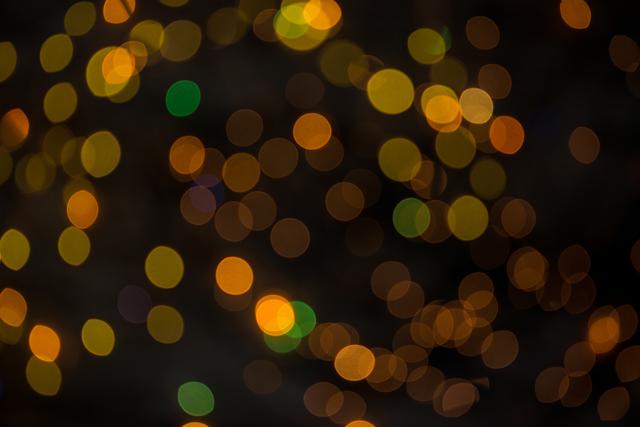 Abstract bokeh lights in warm tones create a festive and celebratory atmosphere. Ideal for use in holiday-themed designs, Christmas cards, party invitations, and festive decorations. The blurred and glowing lights add a touch of warmth and sparkle, perfect for creating a cozy and joyful mood.