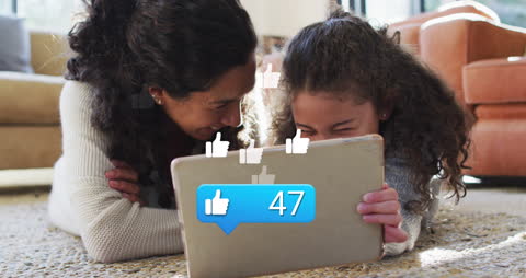 Mother and Daughter Engaging With Digital Media on Tablet