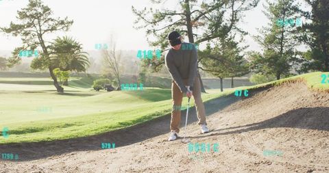 Golfer practicing swing in sand bunker with data analytics