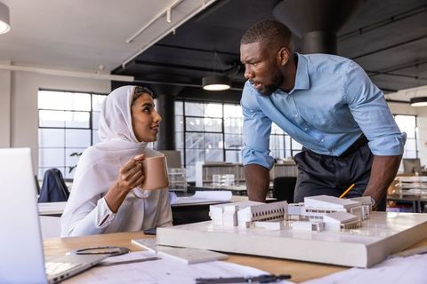 Diverse Coworkers Collaborating on Architectural Project