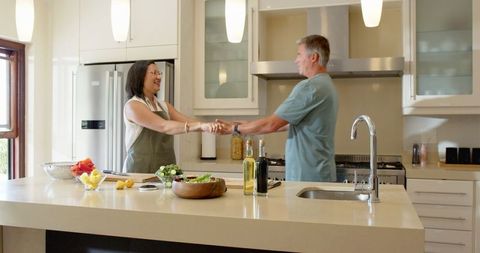 Happy Couple Preparing Fresh Meal in Modern Kitchen