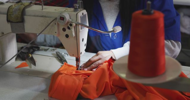 Factory Worker Sewing Bright Orange Fabric on Industrial Sewing Machine - Download Free Stock Images Pikwizard.com