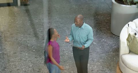 Business Professionals Discussing in Corporate Lobby