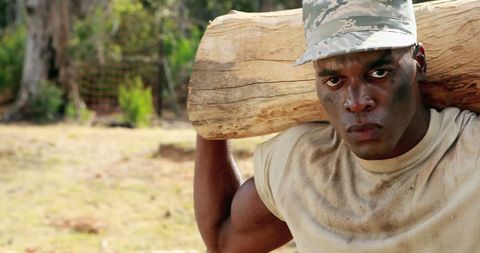 Strong Military Man Engaged in Intense Log Carrying Exercise - Download Free Stock Images Pikwizard.com