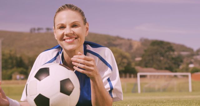 Woman Football Player Laying on Field with Ball Smiling - Download Free Stock Images Pikwizard.com
