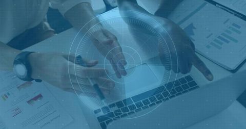 Colleagues pointing and gesturing over laptop with analytics charts and digital interface overlay