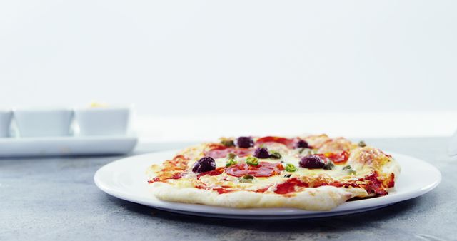 Freshly Baked Pizza with Olives and Peppers on White Plate - Download Free Stock Images Pikwizard.com