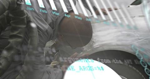 Automotive technician inspecting wheel and fender with digital code overlay for diagnostics