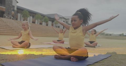 Diverse Girls Practicing Yoga Outdoors at Dusk