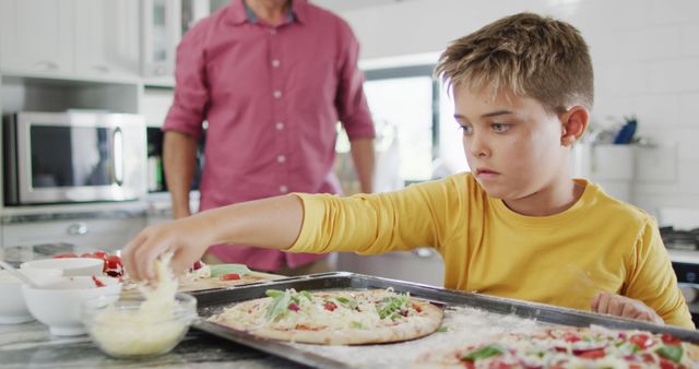 Boy Preparing Homemade Pizza with Father in Kitchen - Download Free Stock Images Pikwizard.com
