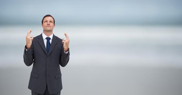 Businessman standing with crossed fingers, hoping for success. Ideal for business concepts such as determination, hope, professional aspirations, achieving goals, and confidence in the corporate world. Useful for articles, blogs, advertising, and marketing materials focusing on business success and motivation.