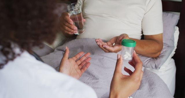 Caregiver providing medication and water to patient lying in bed. Ideal for illustrating healthcare assistance, home care, hospital treatment, nursing support, and caregiving scenarios.