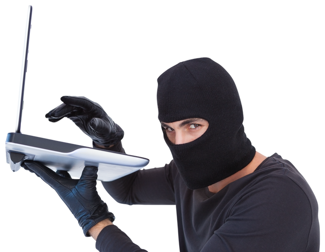 Focused Burglar Hacking Into Laptop Wearing Black Gloves And Mask - Download Free Stock Videos Pikwizard.com