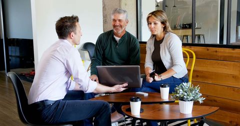 Casual Business Meeting Over Coffee in Modern Office Cafe