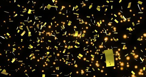 Falling golden confetti with glowing lights on black background
